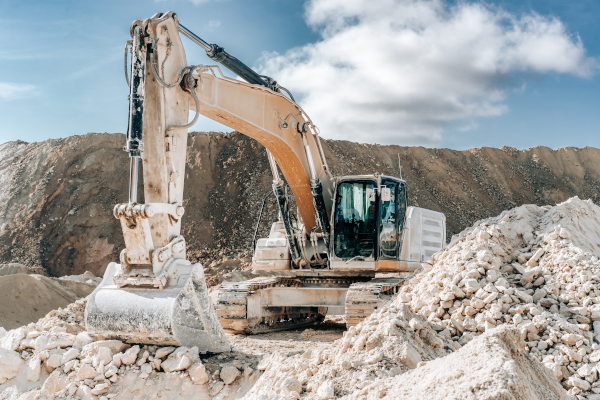 A large P&H excavator sitting on top of a pile of rocks.