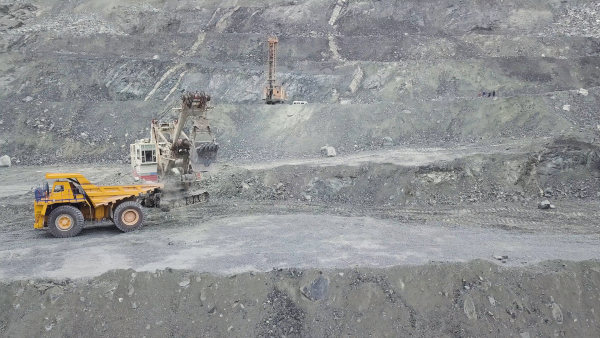 Two mining cranes and a mining truck on a mining site